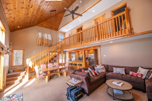 carpeted living room featuring ceiling fan, wood ceiling, and high vaulted ceiling