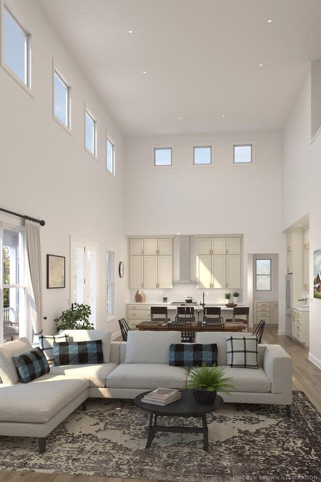 living room with a high ceiling and hardwood / wood-style flooring