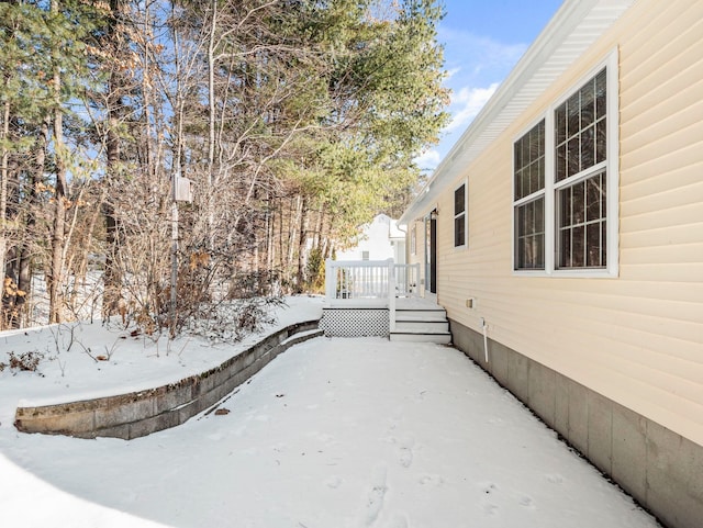 yard layered in snow with a deck