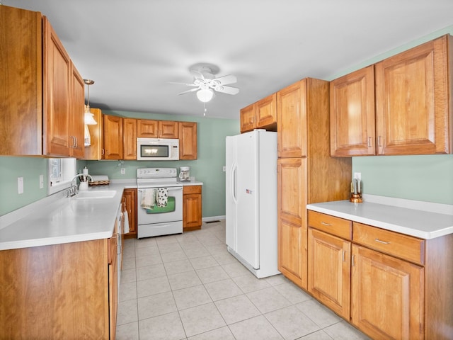 kitchen with light tile patterned flooring, sink, hanging light fixtures, ceiling fan, and white appliances