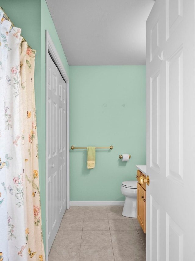 bathroom featuring vanity, tile patterned floors, and toilet