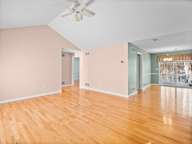 empty room with ceiling fan with notable chandelier and light wood-type flooring