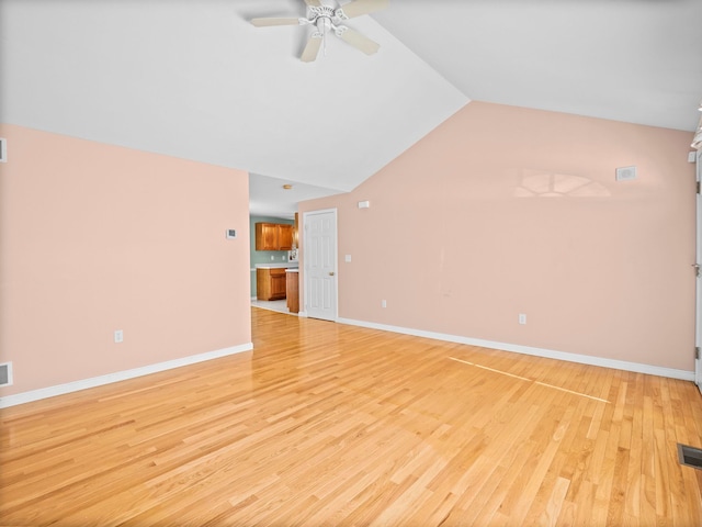 unfurnished living room with vaulted ceiling, ceiling fan, and light hardwood / wood-style floors