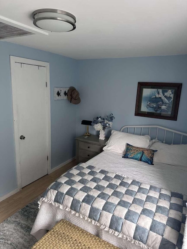 bedroom with hardwood / wood-style flooring and a closet