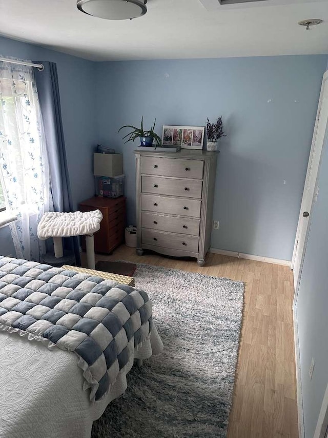 bedroom with light hardwood / wood-style floors