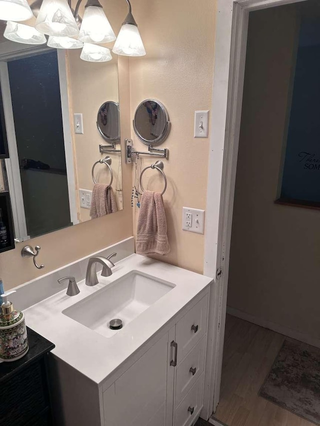 bathroom with vanity and hardwood / wood-style floors