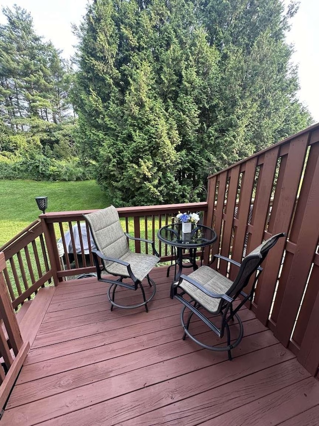 wooden deck featuring a yard