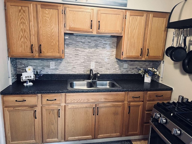 kitchen with sink, stainless steel range with gas stovetop, and backsplash