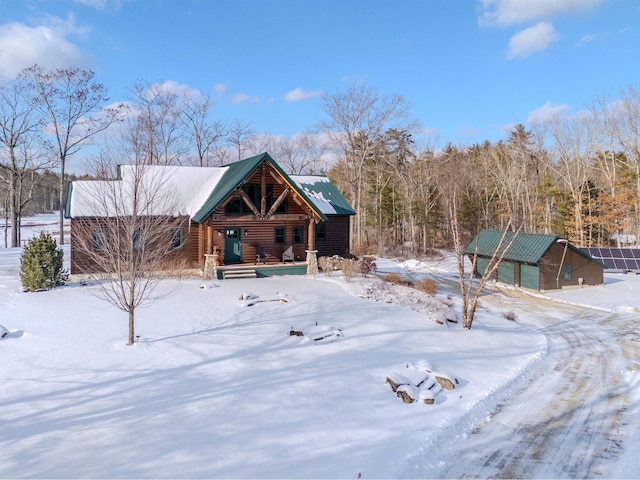 view of front facade featuring an outbuilding, a garage, and covered porch