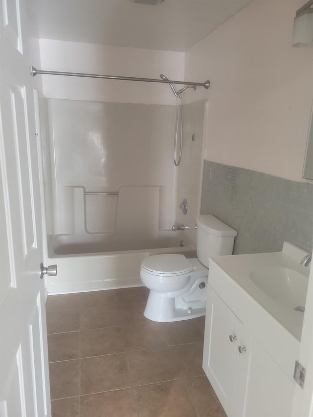 full bathroom featuring vanity, tub / shower combination, tile patterned floors, and toilet