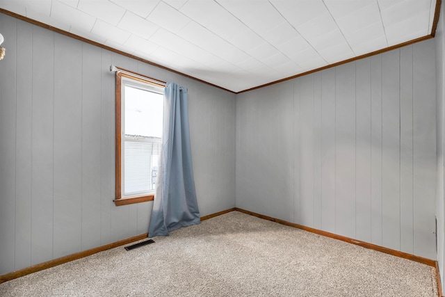 carpeted empty room with ornamental molding