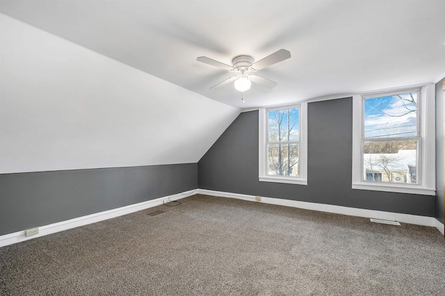 additional living space with lofted ceiling, carpet flooring, and ceiling fan