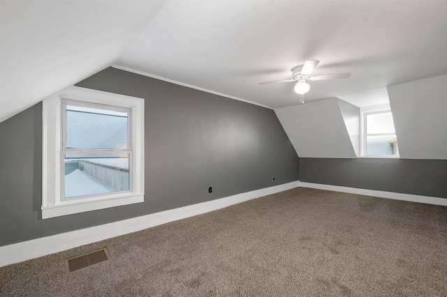 bonus room with vaulted ceiling, ceiling fan, and carpet floors