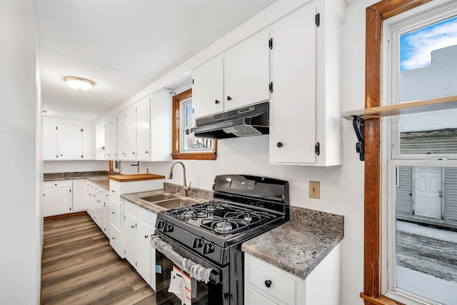 kitchen featuring white cabinetry, sink, a wealth of natural light, and black gas range