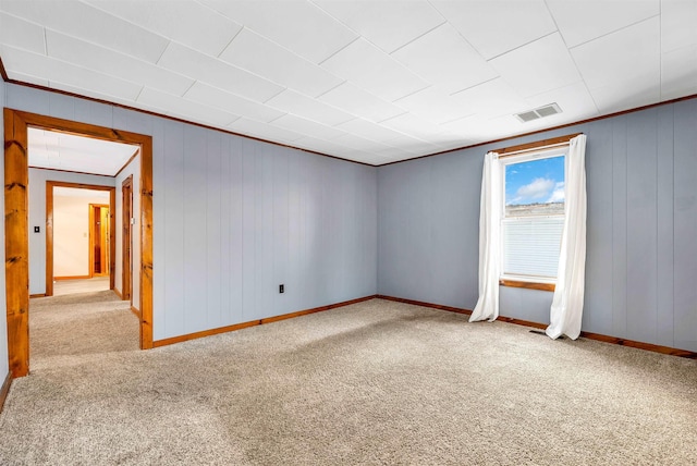 empty room featuring light carpet and ornamental molding