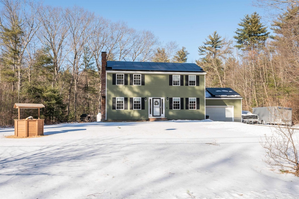 view of front of home featuring a garage and solar panels