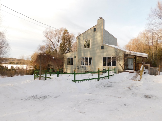 view of snow covered back of property