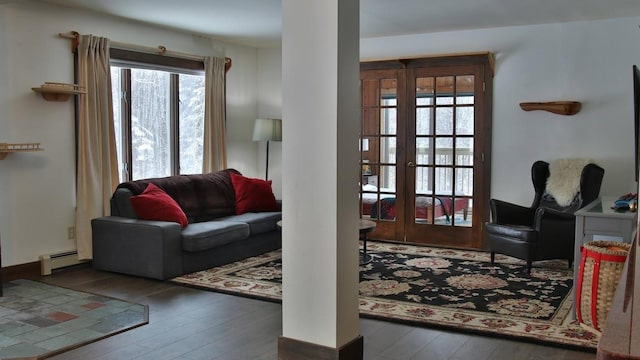 living room featuring a baseboard heating unit and dark hardwood / wood-style flooring