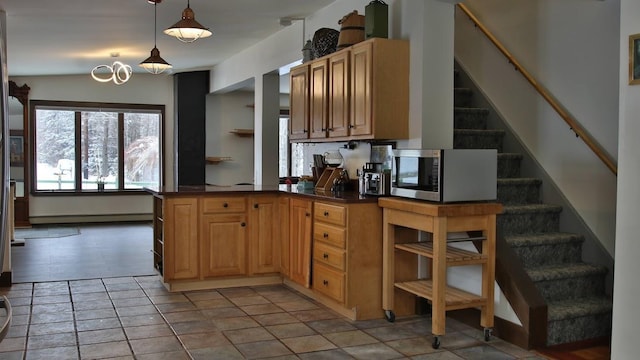 kitchen with hanging light fixtures, a baseboard radiator, and kitchen peninsula