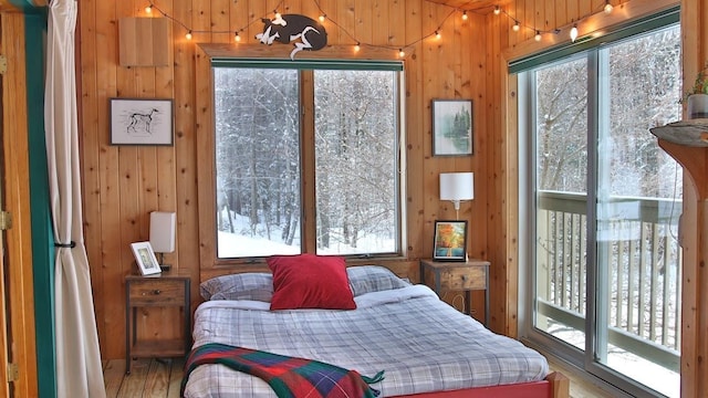 bedroom featuring hardwood / wood-style flooring and wooden walls