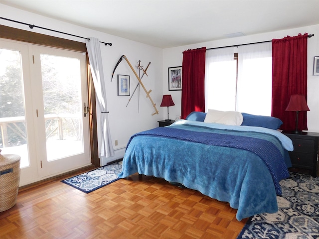 bedroom featuring parquet floors and access to outside