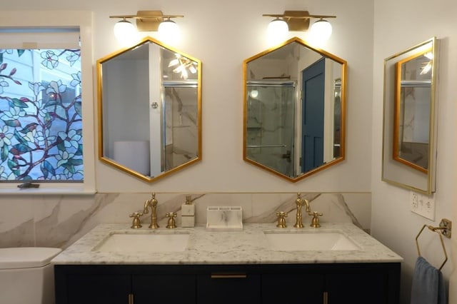 bathroom with a shower with door, vanity, backsplash, and toilet