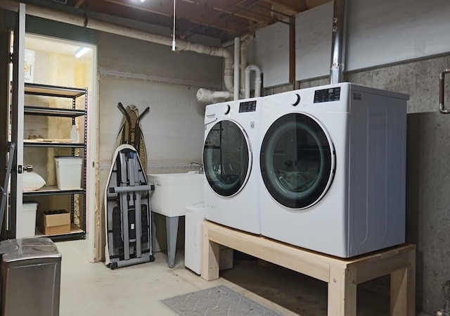 clothes washing area with washing machine and dryer