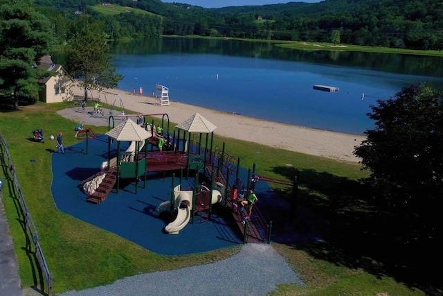 view of play area with a water view and a lawn