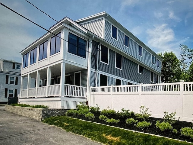 view of side of property with covered porch