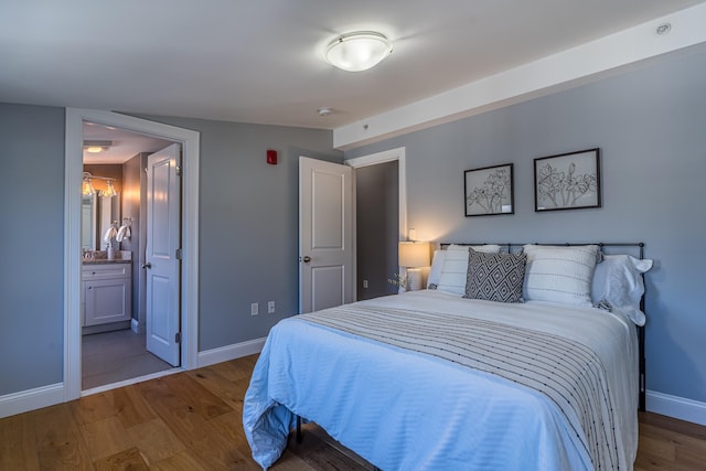 bedroom featuring ensuite bathroom and wood-type flooring