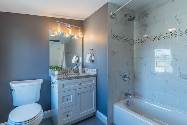 full bathroom with tiled shower / bath, vanity, and toilet