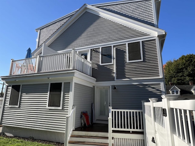 rear view of property featuring a balcony