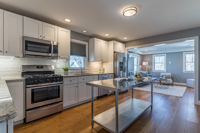 kitchen with appliances with stainless steel finishes, sink, and white cabinets