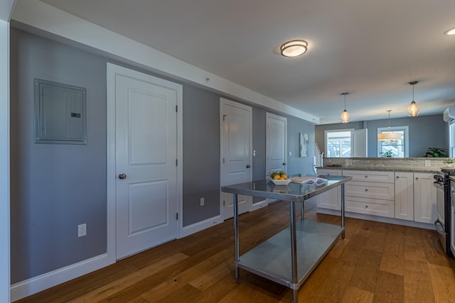 kitchen featuring pendant lighting, electric panel, dark hardwood / wood-style floors, and white cabinets