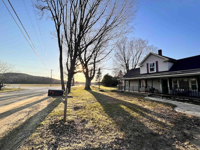 view of yard with covered porch