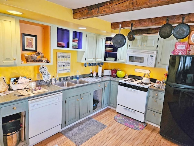 kitchen featuring beam ceiling, sink, white appliances, and light hardwood / wood-style flooring