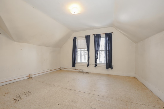 additional living space featuring lofted ceiling