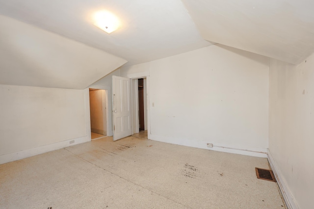 additional living space featuring lofted ceiling