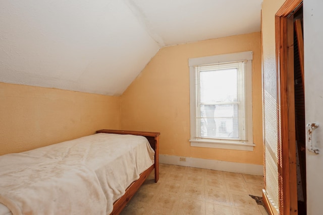 bedroom featuring vaulted ceiling