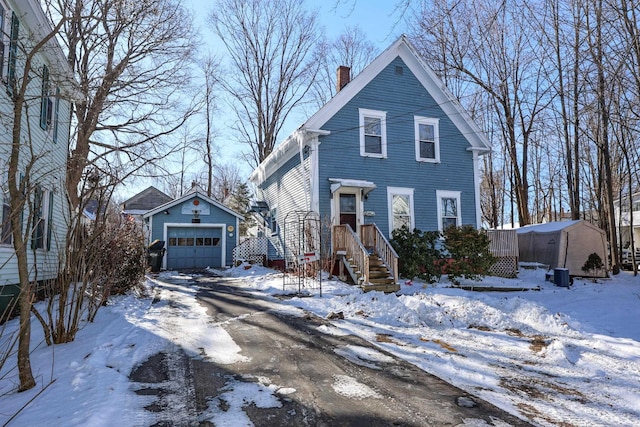 view of front of house with a garage and an outdoor structure