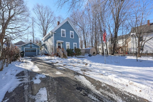 view of front of house featuring a garage and an outdoor structure