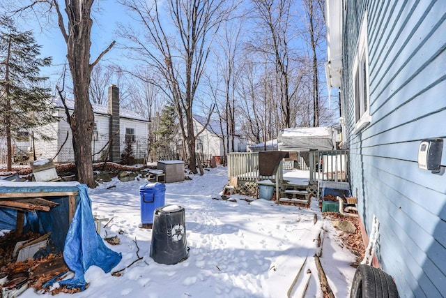 snowy yard with a wooden deck