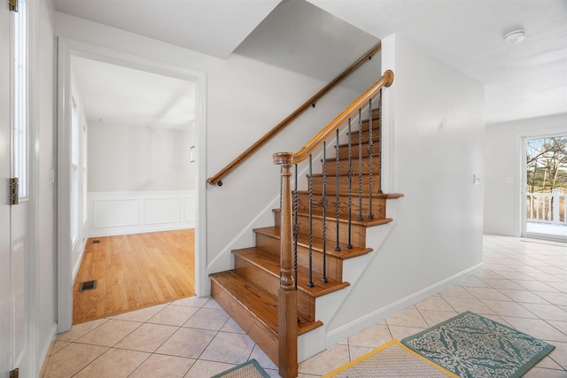 staircase featuring tile patterned flooring