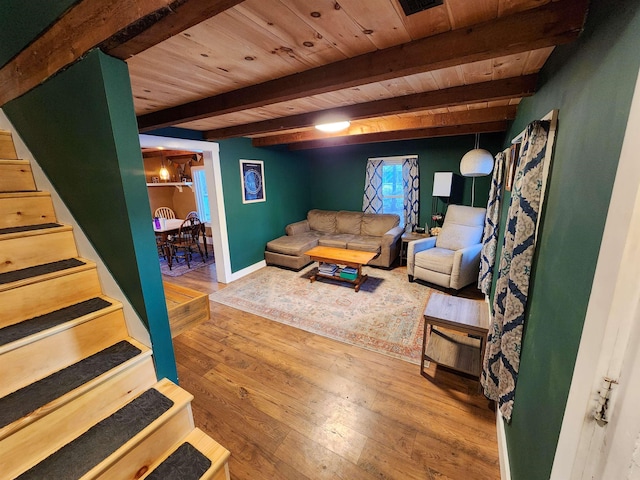 living room with wood ceiling, beam ceiling, and light hardwood / wood-style flooring