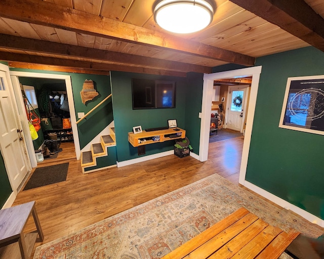 corridor featuring hardwood / wood-style flooring, beam ceiling, and wooden ceiling