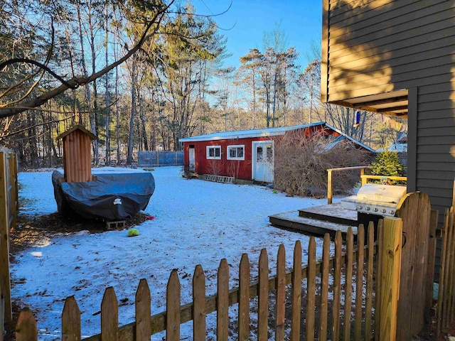 snowy yard featuring an outdoor structure