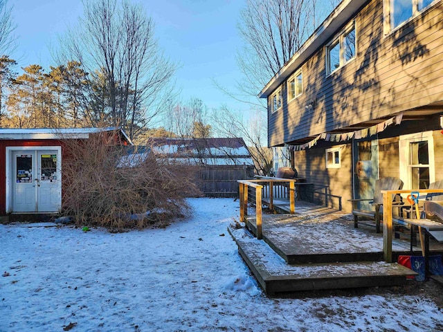 yard layered in snow featuring a wooden deck