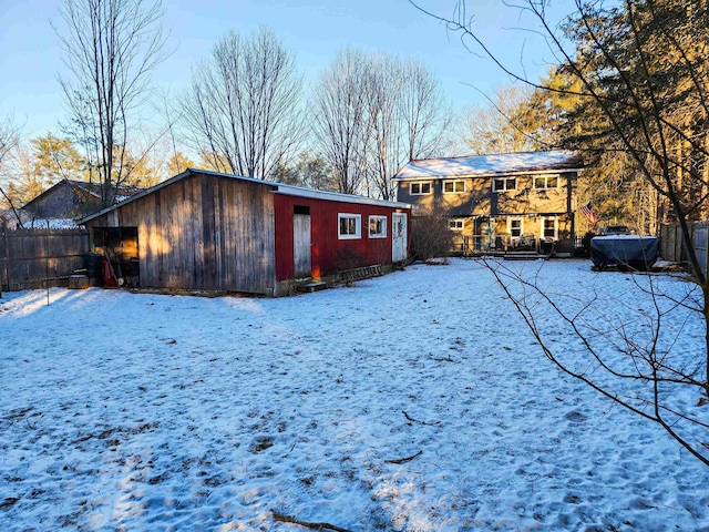 view of snow covered rear of property