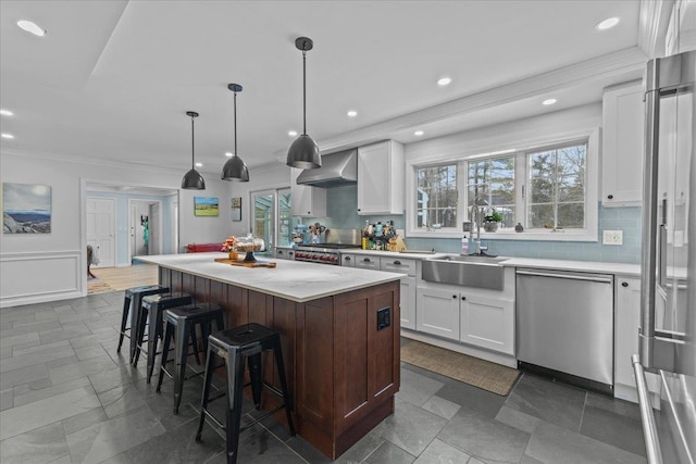 kitchen with appliances with stainless steel finishes, a center island, and white cabinets