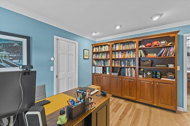 office space with ornamental molding and light wood-type flooring